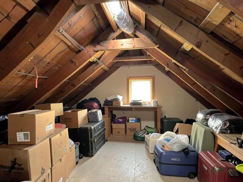 Residential attic filled with old boxes and stored luggage