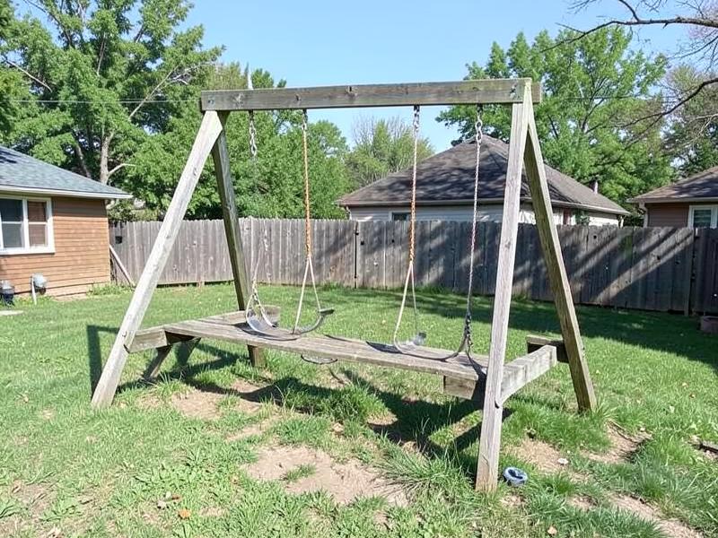 Weathered wooden backyard swing set ready to be taken down